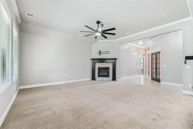 9041 NW 147th Ter, Yukon, OK 73099 - unfurnished living room featuring light carpet, ornamental molding, a stone fireplace, and a ceiling fan