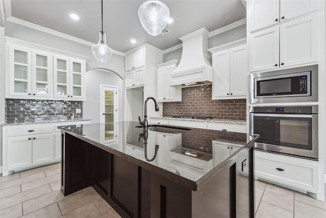 9041 NW 147th Ter, Yukon, OK 73099 - kitchen featuring stainless steel appliances, custom exhaust hood, backsplash, ornamental molding, and white cabinetry