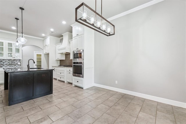 9041 NW 147th Ter, Yukon, OK 73099 - kitchen featuring stainless steel appliances, custom exhaust hood, decorative backsplash, ornamental molding, and arched walkways
