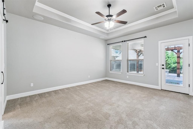 9041 NW 147th Ter, Yukon, OK 73099 - unfurnished room featuring a raised ceiling, crown molding, plenty of natural light, and carpet flooring