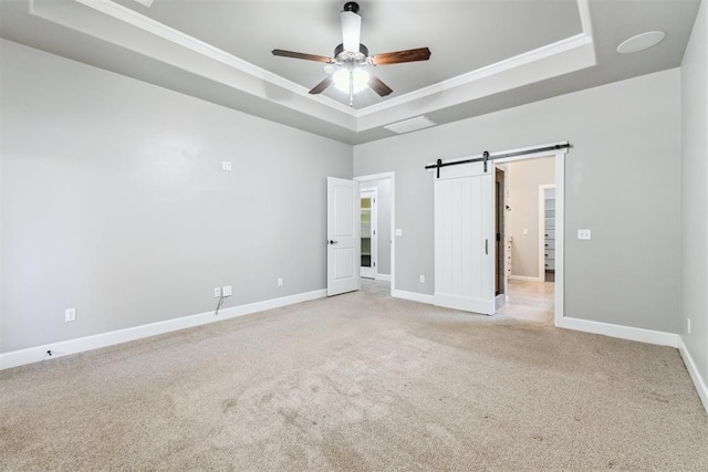 9041 NW 147th Ter, Yukon, OK 73099 - unfurnished bedroom featuring a raised ceiling, light carpet, ornamental molding, a barn door, and ceiling fan