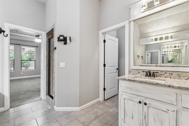 9041 NW 147th Ter, Yukon, OK 73099 - bathroom featuring vanity, tile patterned floors, a shower with shower door, and ceiling fan