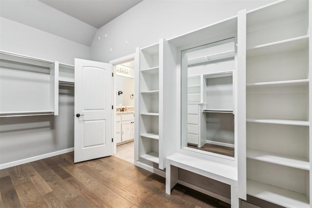 9041 NW 147th Ter, Yukon, OK 73099 - walk in closet with wood finished floors and lofted ceiling