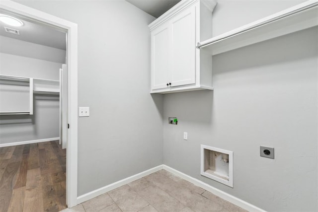 9041 NW 147th Ter, Yukon, OK 73099 - laundry area featuring hookup for an electric dryer, washer hookup, and cabinet space