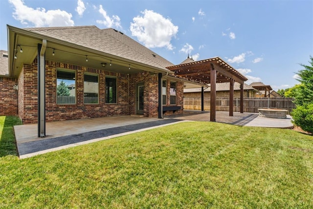 9041 NW 147th Ter, Yukon, OK 73099 - rear view of property featuring a patio, a pergola, brick siding, a shingled roof, and a fire pit