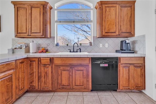 1045 Belmont Pl, Yukon, OK 73099 - kitchen featuring dishwasher, brown cabinetry, tasteful backsplash, and healthy amount of natural light