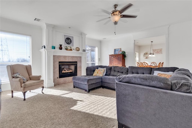 1045 Belmont Pl, Yukon, OK 73099 - living room with light colored carpet, a ceiling fan, and a tile fireplace