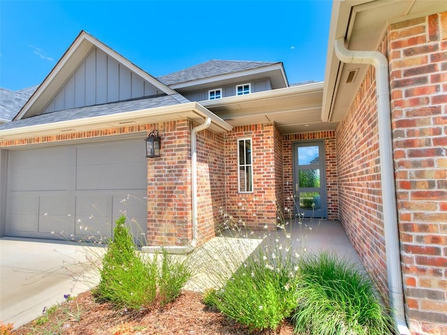 201 Pont Neuf Ct, Edmond, OK 73034 - view of front facade featuring brick siding, a garage, board and batten siding, driveway, and a shingled roof