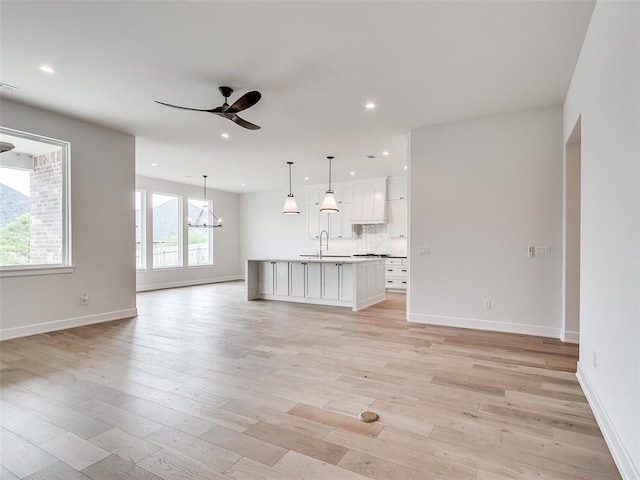 201 Pont Neuf Ct, Edmond, OK 73034 - unfurnished living room with ceiling fan, light wood-style floors, and recessed lighting