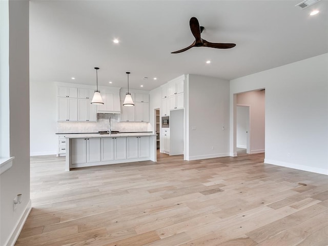 201 Pont Neuf Ct, Edmond, OK 73034 - kitchen with decorative backsplash, white cabinetry, recessed lighting, ceiling fan, and light wood finished floors