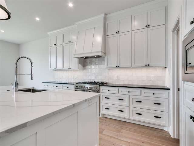 201 Pont Neuf Ct, Edmond, OK 73034 - kitchen with backsplash, recessed lighting, white cabinets, and light wood-type flooring