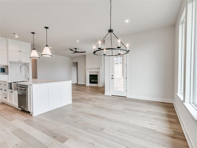 201 Pont Neuf Ct, Edmond, OK 73034 - kitchen featuring appliances with stainless steel finishes, open floor plan, light wood-style flooring, white cabinetry, and recessed lighting