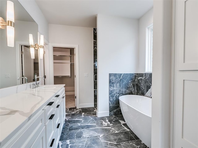 201 Pont Neuf Ct, Edmond, OK 73034 - full bath featuring a freestanding tub, double vanity, tile walls, a spacious closet, and wainscoting