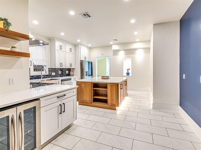 701 NW 21st St, Oklahoma City, OK 73103 - kitchen featuring open shelves, appliances with stainless steel finishes, beverage cooler, backsplash, and light countertops