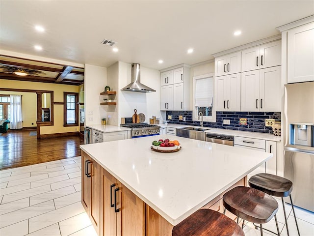 701 NW 21st St, Oklahoma City, OK 73103 - kitchen featuring wall chimney exhaust hood, refrigerator with ice dispenser, dishwasher, recessed lighting, and a center island