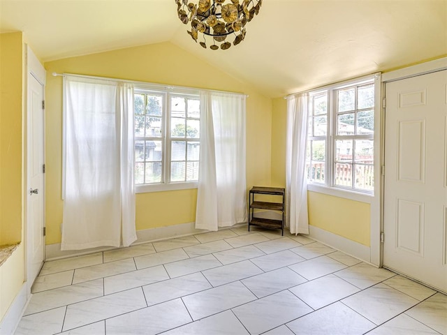 701 NW 21st St, Oklahoma City, OK 73103 - entryway with a chandelier, plenty of natural light, lofted ceiling, and light tile patterned floors