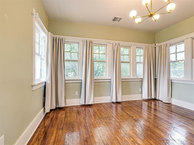 701 NW 21st St, Oklahoma City, OK 73103 - spare room with wood-type flooring and a chandelier