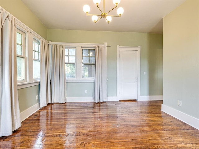 701 NW 21st St, Oklahoma City, OK 73103 - spare room with a chandelier and wood finished floors