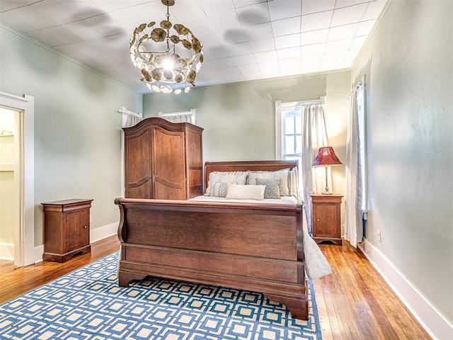 701 NW 21st St, Oklahoma City, OK 73103 - bedroom with light wood-style floors, a chandelier, and crown molding