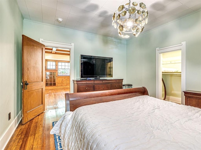 701 NW 21st St, Oklahoma City, OK 73103 - bedroom featuring a chandelier, hardwood / wood-style flooring, and ornamental molding