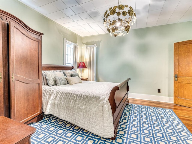 701 NW 21st St, Oklahoma City, OK 73103 - bedroom with light wood-style flooring and a chandelier