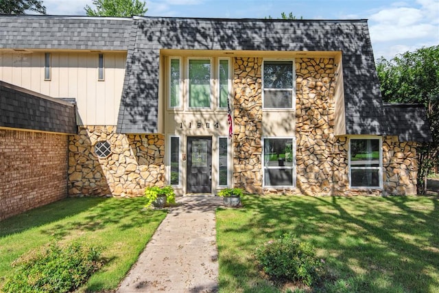 11904 Somerville Dr, Yukon, OK 73099 - view of front of home with stone siding, a shingled roof, and a front lawn