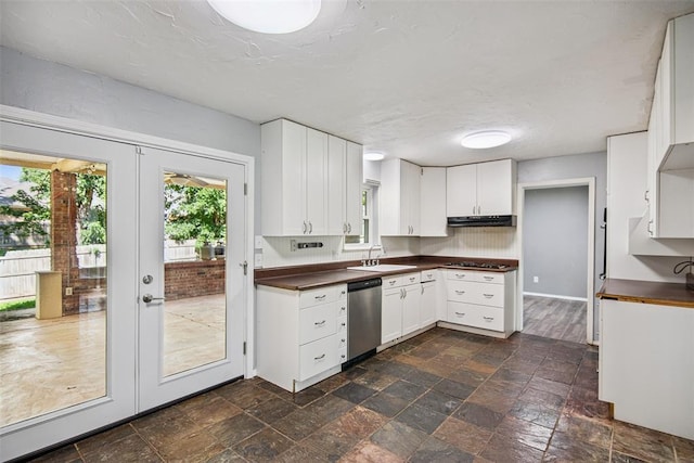 11904 Somerville Dr, Yukon, OK 73099 - kitchen with stainless steel dishwasher, healthy amount of natural light, dark countertops, and black stovetop