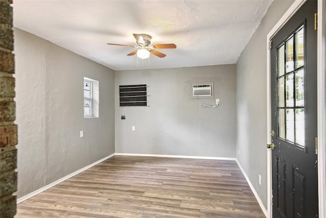 11904 Somerville Dr, Yukon, OK 73099 - unfurnished room with a ceiling fan, wood finished floors, and an AC wall unit