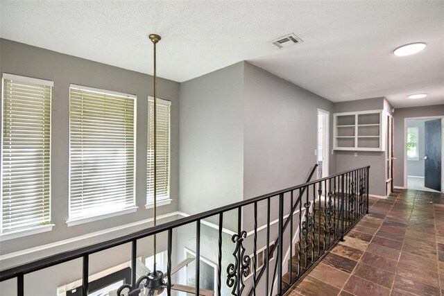 11904 Somerville Dr, Yukon, OK 73099 - corridor featuring an upstairs landing and stone finish flooring