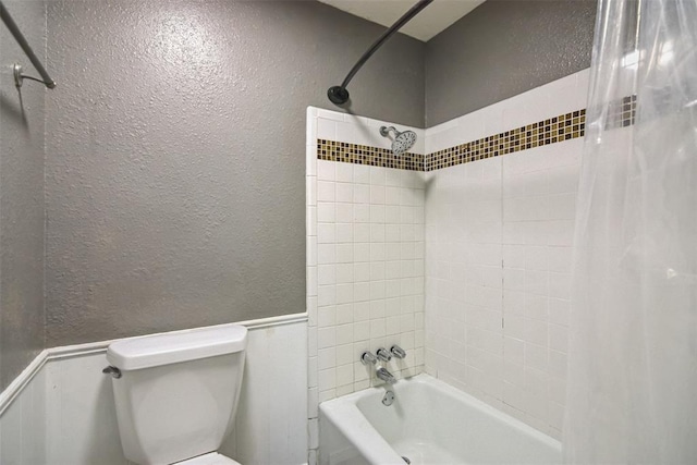 11904 Somerville Dr, Yukon, OK 73099 - full bath featuring a textured wall, shower / tub combo, and wainscoting
