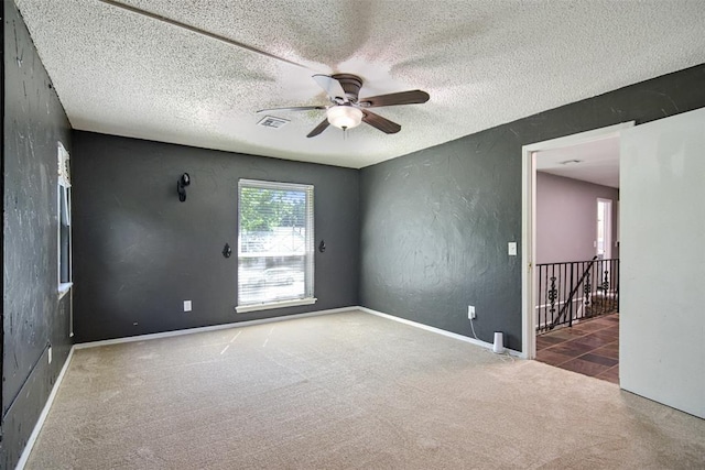 11904 Somerville Dr, Yukon, OK 73099 - empty room with carpet flooring, ceiling fan, a textured wall, and a textured ceiling
