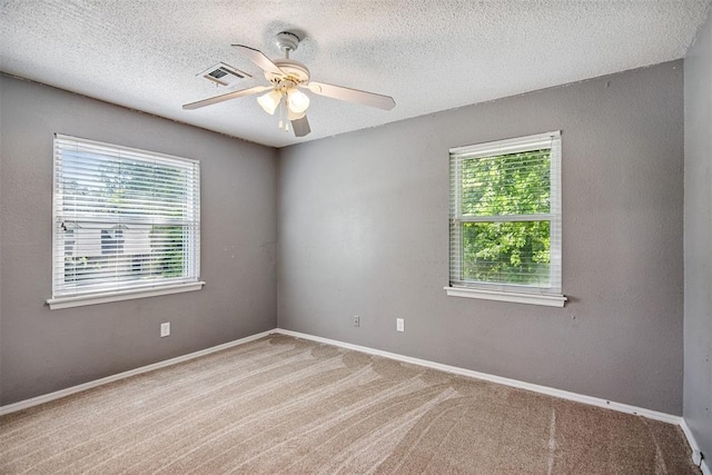 11904 Somerville Dr, Yukon, OK 73099 - spare room with plenty of natural light, ceiling fan, carpet, and a textured ceiling