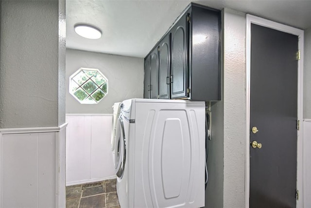 11904 Somerville Dr, Yukon, OK 73099 - laundry area featuring dark stone finish flooring, cabinet space, a textured wall, wainscoting, and washer and dryer