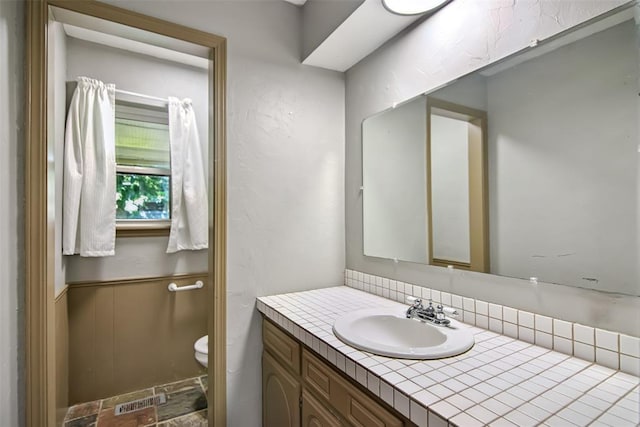 11904 Somerville Dr, Yukon, OK 73099 - bathroom with vanity and a wainscoted wall