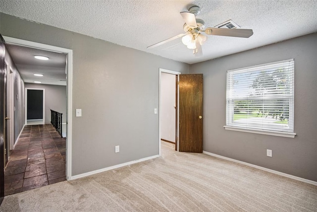 11904 Somerville Dr, Yukon, OK 73099 - unfurnished bedroom featuring carpet flooring, a textured ceiling, and a ceiling fan