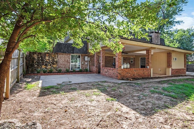 11904 Somerville Dr, Yukon, OK 73099 - back of property featuring brick siding, a patio area, a fenced backyard, ceiling fan, and a chimney