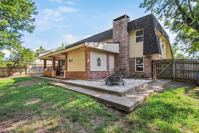 11904 Somerville Dr, Yukon, OK 73099 - back of house with brick siding, a shingled roof, a chimney, a fenced backyard, and a patio