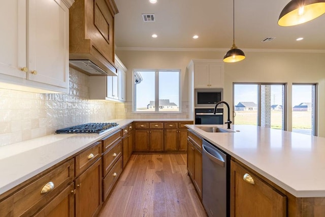 4334 White Ash Dr, Piedmont, OK 73078 - kitchen featuring appliances with stainless steel finishes, brown cabinets, light wood-style floors, light countertops, and backsplash