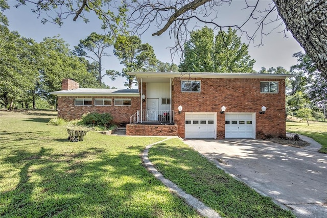2299 Coretta Ave, Duncan, OK 73534 - tri-level home with brick siding, concrete driveway, a chimney, a garage, and a front yard