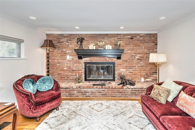 2299 Coretta Ave, Duncan, OK 73534 - living room featuring wood finished floors, crown molding, recessed lighting, and a fireplace