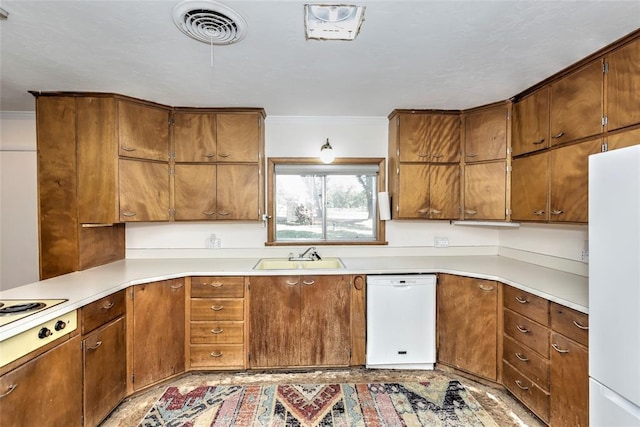 2299 Coretta Ave, Duncan, OK 73534 - kitchen featuring white appliances, light countertops, brown cabinetry, and ornamental molding