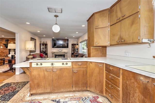 2299 Coretta Ave, Duncan, OK 73534 - kitchen featuring a fireplace, cooktop, open floor plan, a peninsula, and light countertops