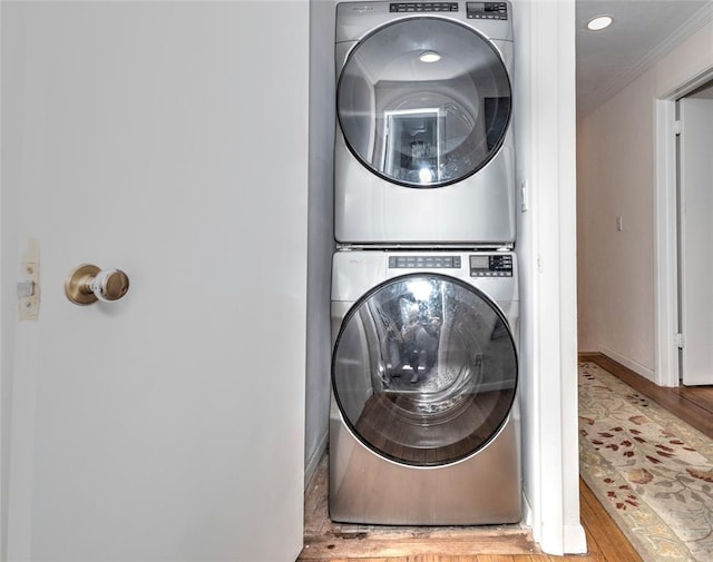 2299 Coretta Ave, Duncan, OK 73534 - washroom with estacked washer and dryer, wood finished floors, and ornamental molding