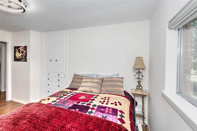 2299 Coretta Ave, Duncan, OK 73534 - bedroom featuring wood finished floors and multiple windows
