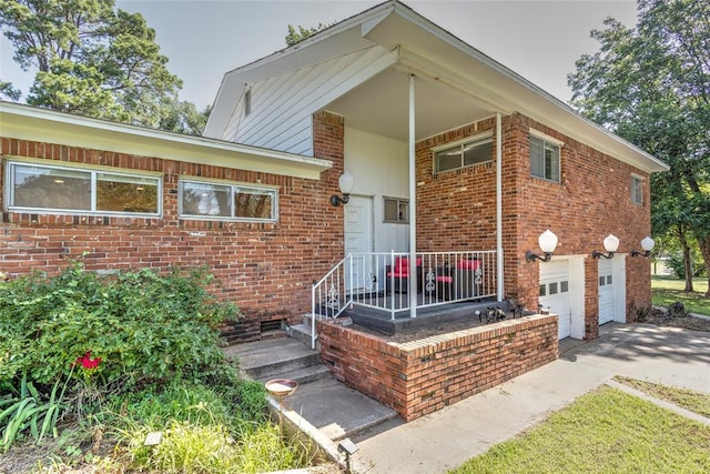 2299 Coretta Ave, Duncan, OK 73534 - view of front of house with an attached garage, concrete driveway, and brick siding