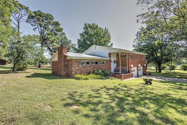 2299 Coretta Ave, Duncan, OK 73534 - back of house featuring brick siding, a chimney, a garage, a yard, and concrete driveway