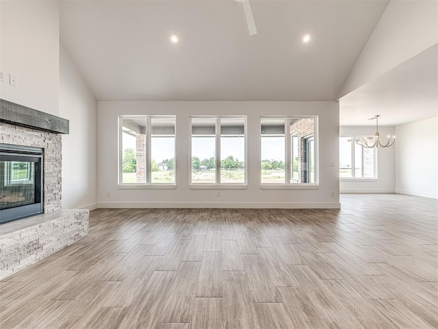 6881 Lake View Ct, Cashion, OK 73016 - unfurnished living room with a fireplace, a chandelier, high vaulted ceiling, light wood-style floors, and recessed lighting