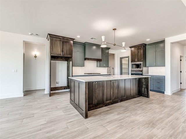 6881 Lake View Ct, Cashion, OK 73016 - kitchen with stainless steel microwave, light countertops, backsplash, premium range hood, and light wood-style floors
