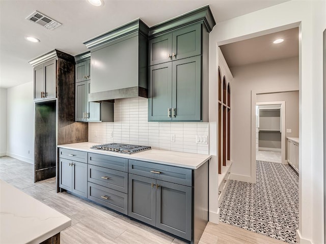 6881 Lake View Ct, Cashion, OK 73016 - kitchen featuring stainless steel gas stovetop, light stone counters, tasteful backsplash, recessed lighting, and custom range hood