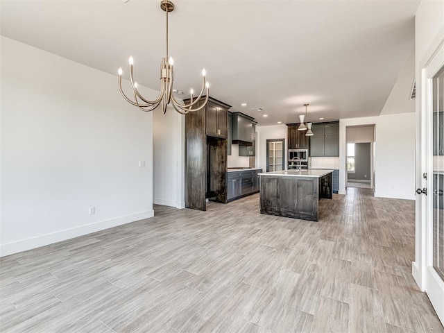 6881 Lake View Ct, Cashion, OK 73016 - kitchen with light countertops, dark brown cabinets, open floor plan, a chandelier, and wall chimney range hood